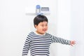 A fat boy is measuring his height himself in hospital Royalty Free Stock Photo