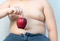 Fat boy pick up red apple Royalty Free Stock Photo