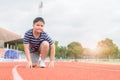 Fat boy in starting position ready for running. Royalty Free Stock Photo