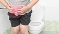 Fat boy suffer stomach and sit in toilet, diarrhea Royalty Free Stock Photo