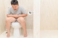 Fat boy suffer stomach and sit in toilet, Royalty Free Stock Photo