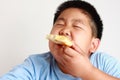 The Fat Boy Too much weight Eat pizza with a lot of dough. Royalty Free Stock Photo