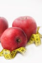 Fat Burning. Looe Weight. Red Apple with Measure Tape for Diet and Fitness with Copy space . Isoalted on White Background. Vertica Royalty Free Stock Photo