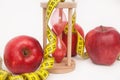 Fat Burning and Weight loss process. Diet and Fitness Concept. Red Apples and Tape Measure Isolated, close up. White Background. V Royalty Free Stock Photo