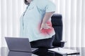 Fat businesswoman rubbing her waist while working