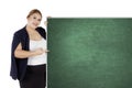 Fat businesswoman showing an empty chalkboard Royalty Free Stock Photo