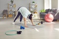 Overweight woman doing fitness exercises on a sports mat during her weight loss workout at home Royalty Free Stock Photo