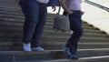 Fat couple walking on stairs, global problem of obesity, surveys and statistics