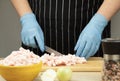 Fat is cut into small pieces. Hands of a cook cutting lard with a knife into small pieces to prepare food. home cuisine.