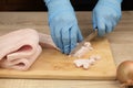 Fat is cut into small pieces. Hands of a cook cutting lard with a knife into small pieces to prepare food. home cuisine