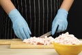 Fat is cut into small pieces. Hands of a cook cutting lard with a knife into small pieces to prepare food. home cuisine