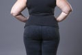 Fat female buttocks in blue jeans, overweight woman body closeup Royalty Free Stock Photo