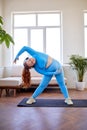fat freckled woman doing stretching exercise at home, on fitness mat Royalty Free Stock Photo