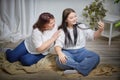 Fat funny funny adult mother and daughter posing, taking selfies indoors. Body positive, friendly family in room Royalty Free Stock Photo