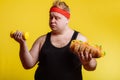 Fat man choise between sport and fastfood Royalty Free Stock Photo