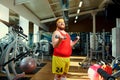 Fat funny man with dumbbells in the gym Royalty Free Stock Photo