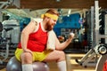 Fat funny man with dumbbells in the gym Royalty Free Stock Photo