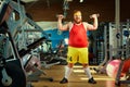 Fat funny man in the gym. Royalty Free Stock Photo