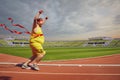 Fat funny man runs to the finish on track in the stadium. Royalty Free Stock Photo