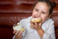 fat girl feels hungry and eat sweet snack cake while sitting on floor watching tv