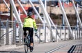 Fat girl rides a bicycle on the Tilikum Crossing Bridge on a dedicated bike path preferring to fight overweight