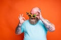 Fat happy man with beard, tattoos and sunglasses is ready for the summer