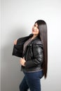 Fat latin young adult woman shows off her beautiful very long straight black shiny silky hair wears black fur jacket looks modern, Royalty Free Stock Photo