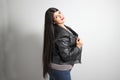 Fat latin young adult woman shows off her beautiful very long straight black shiny silky hair wears black fur jacket looks modern, Royalty Free Stock Photo