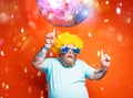 Fat man with beard, tattoos and sunglasses dances music on a disco Royalty Free Stock Photo