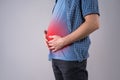 Fat man with bloating and abdominal pain, overweight male body on gray background