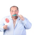 Fat Man in a Blue Shirt, Eating a Lollipop Royalty Free Stock Photo