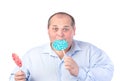 Fat Man in a Blue Shirt, Eating a Lollipop Royalty Free Stock Photo