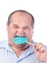 Fat Man in a Blue Shirt, Eating a Lollipop Royalty Free Stock Photo