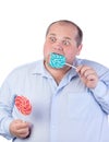 Fat Man in a Blue Shirt, Eating a Lollipop Royalty Free Stock Photo