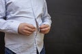 A fat man can`t button his shirt. The concept of obesity. Fragment of a man`s belly Royalty Free Stock Photo