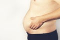 Fat man checking out his weight isolated on white background Royalty Free Stock Photo