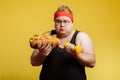 Fat man choise between sport and fastfood Royalty Free Stock Photo