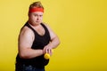 Fat man with dumbbell on yellow background. Motivation for fat people Royalty Free Stock Photo