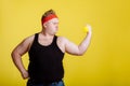 Fat man with dumbbell on yellow background. Motivation for fat people Royalty Free Stock Photo