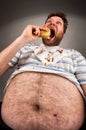 Fat man eating burger Royalty Free Stock Photo