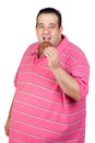 Fat man eating a chocolate muffin Royalty Free Stock Photo