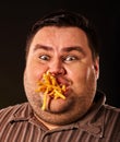Fat man eating fast food french fries for overweight person.