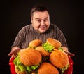 Fat man eating fast food hamberger. Breakfast for overweight person. Royalty Free Stock Photo