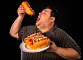 Fat man eating fast food hot dog. Breakfast for overweight person. Royalty Free Stock Photo