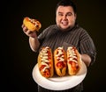 Fat man eating fast food hot dog. Breakfast for overweight person. Royalty Free Stock Photo