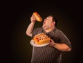 Fat man eating fast food hot dog. Breakfast for overweight person. Royalty Free Stock Photo