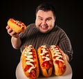 Fat man eating fast food hot dog. Breakfast for overweight person. Royalty Free Stock Photo