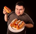 Fat man eating fast food hot dog. Breakfast for overweight person. Royalty Free Stock Photo