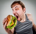 Fat man eating hamburger Royalty Free Stock Photo