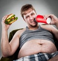 Fat man eating hamburger Royalty Free Stock Photo